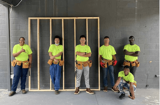 Shawn-with-carpentry-high-school-students-e1644440634825