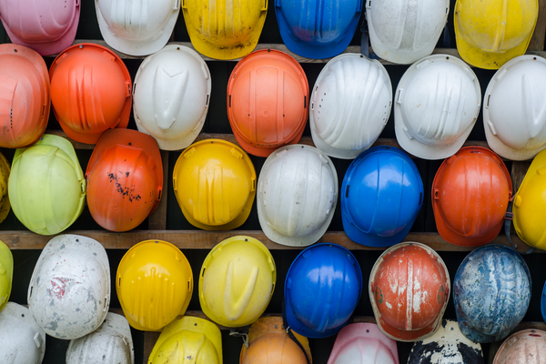 Multicolored hard hats in rows