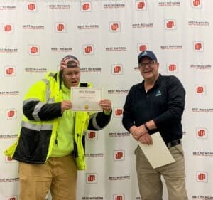 Clark poses with a CORE Carpentry graduate-2