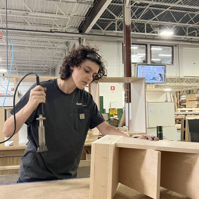 WMCI graduate Billie Beresford learns to assemble shelving in WMCI's Carpentry I course.